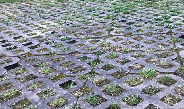 A lattice-paved courtyard, the neutral photo shown before any priming